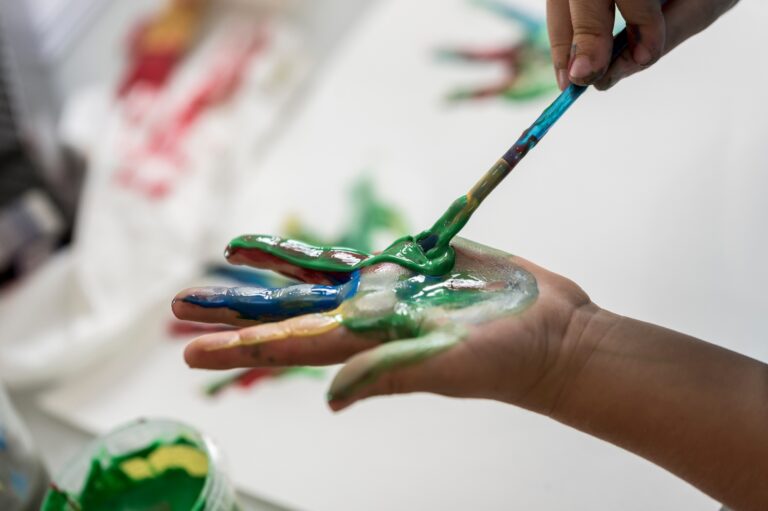 Child,Painting,Its,Hands,With,Colorful,Paint,Using,A,Paintbrush